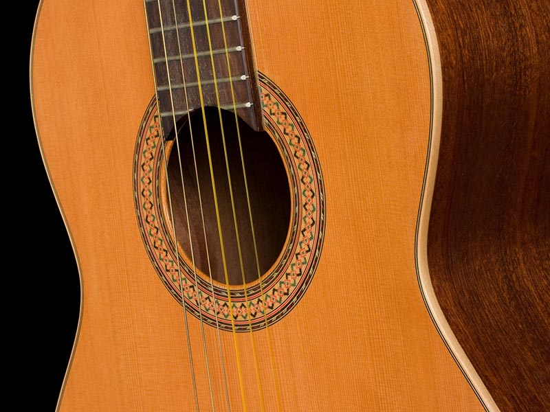 Classical guitar close up on dark background