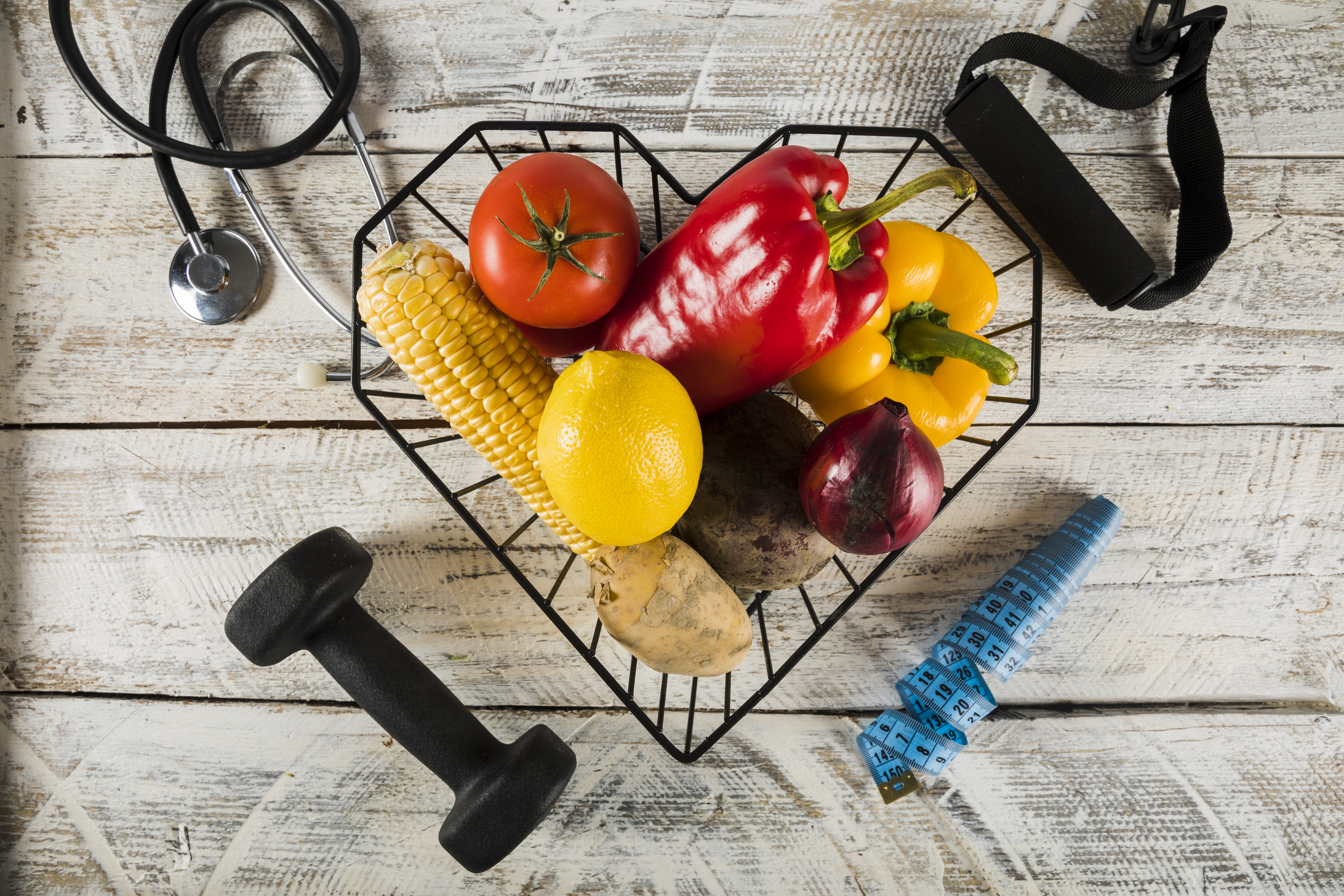 fresh-vegetables-surrounded-by-fitness-equipments-stethoscope-measuring-tape