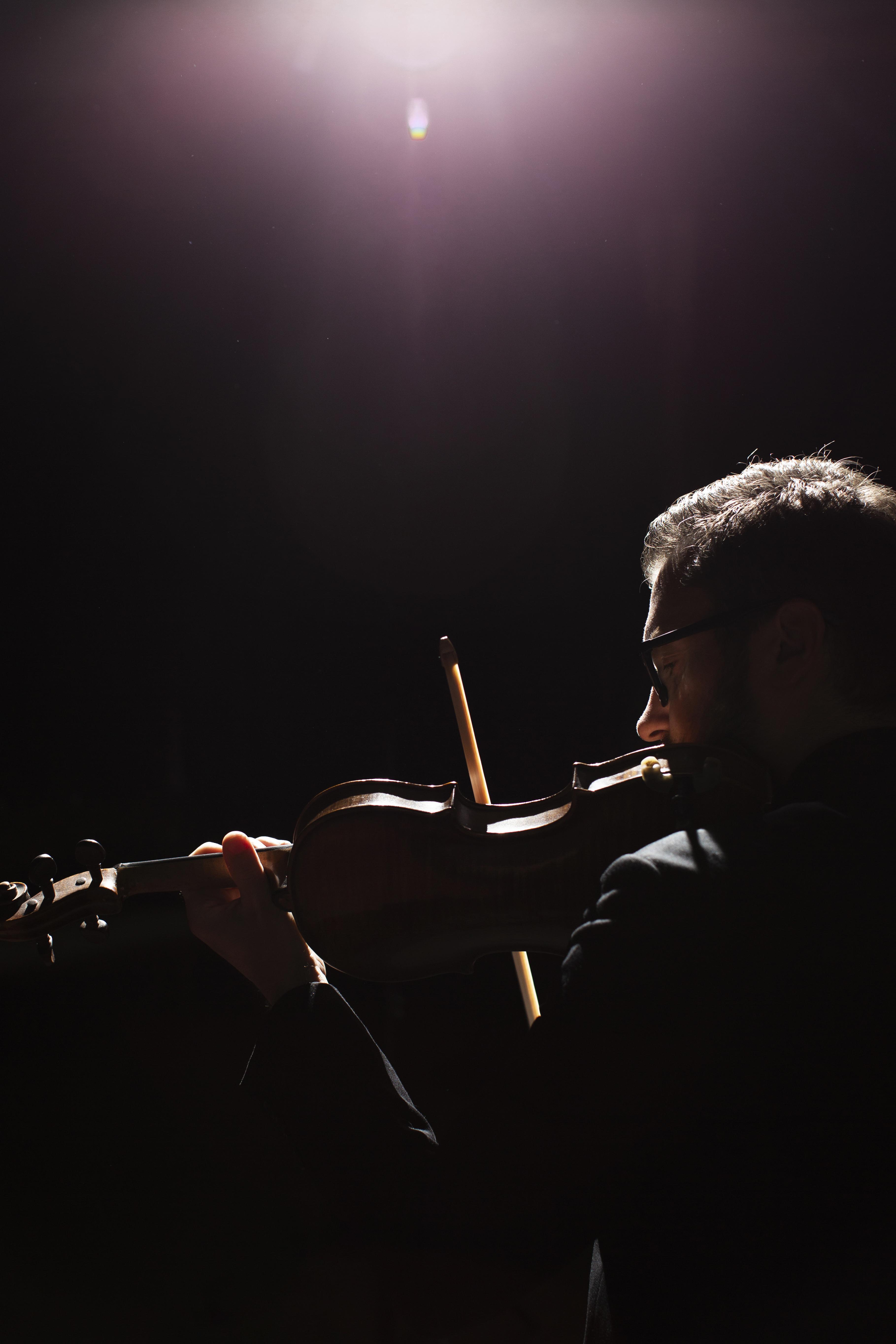 side-view-male-musician-playing-violin-with-copy-space
