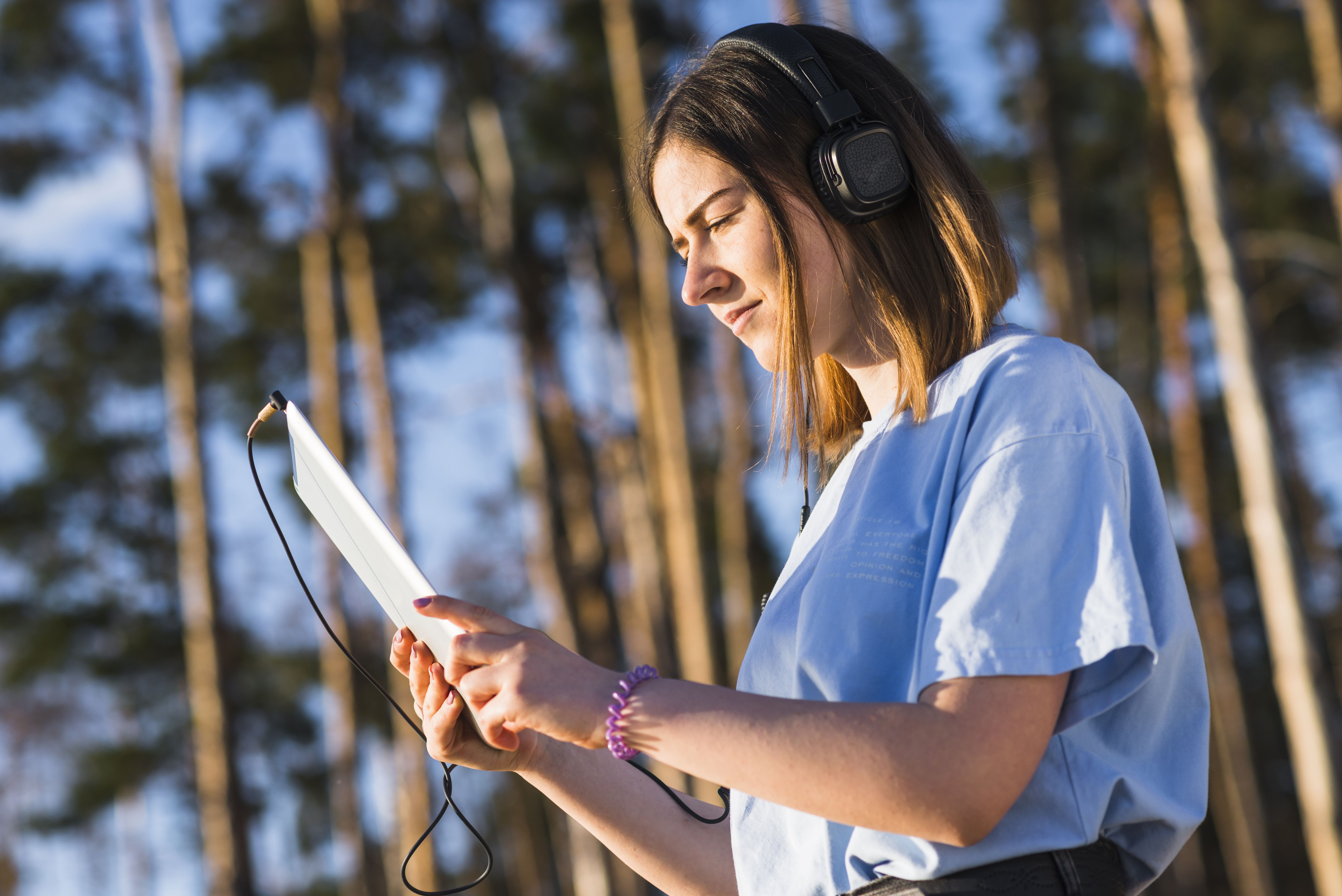 woman-with-tablet-listening-music